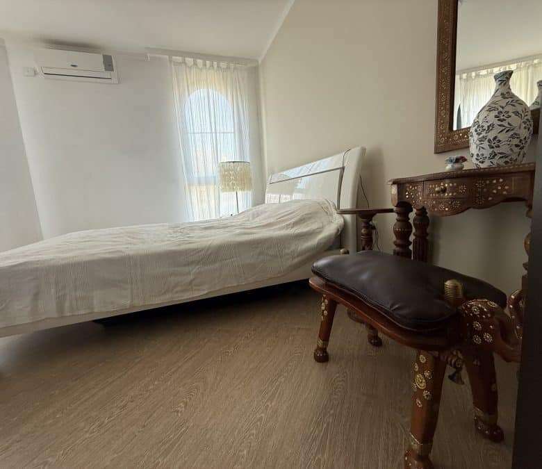 Bright bedroom with large window and sea views in Sveti Vlas apartment.