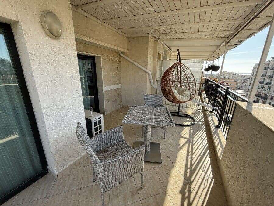 Seaside apartment balcony with outdoor furniture, large terrace, and stunning sea views in Sveti Vla.
