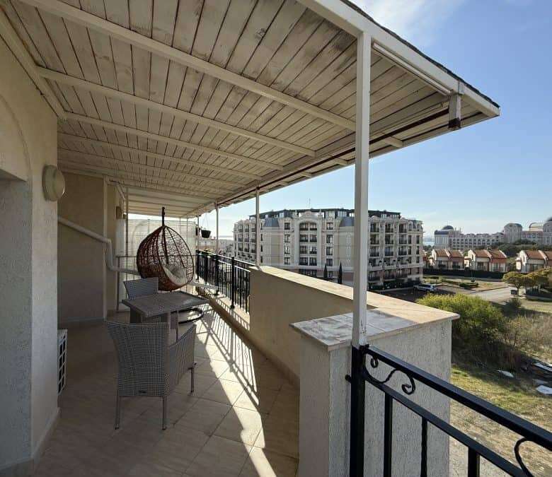 Balcony with sea views, spacious terrace, and outdoor seating in Sveti Vlas top-floor apartment.