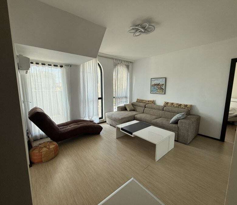 Bright living room with large windows and terrace access, offering stunning sea views in Sveti Vlas.