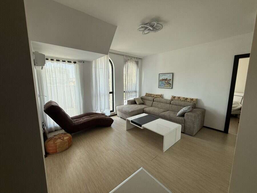 Bright living room with large windows and terrace access, offering stunning sea views in Sveti Vlas.