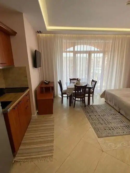 Interior of a studio apartment with pool view, dining area, and modern furnishings in Palazzo, Sunny.