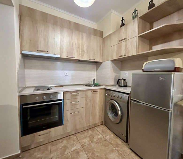 Furnished studio apartment with modern kitchen, washing machine, and compact living space in Ravda.
