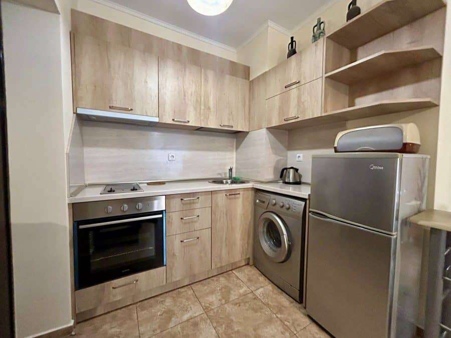 Furnished studio apartment with modern kitchen, washing machine, and compact living space in Ravda.