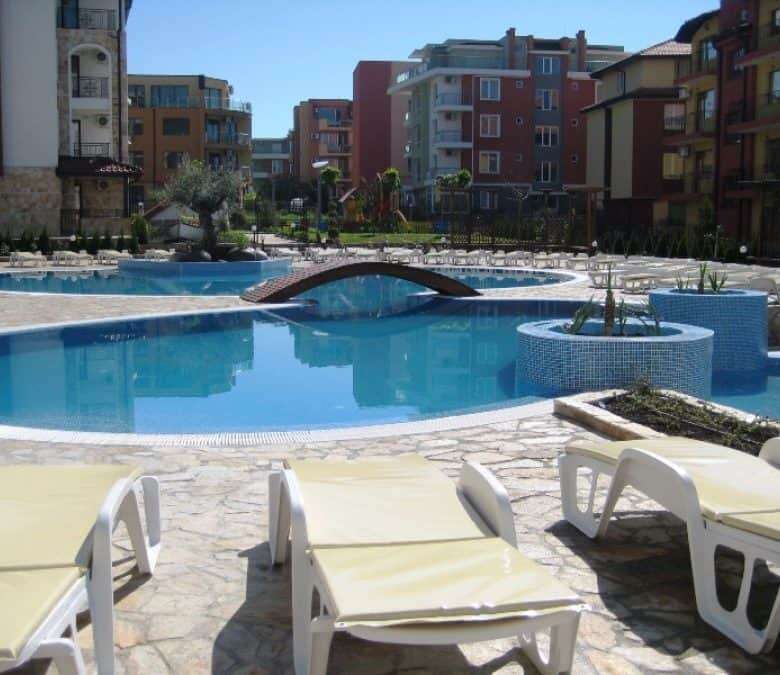 Beautiful outdoor pool area with sun loungers at Apollon apartments, Ravda.