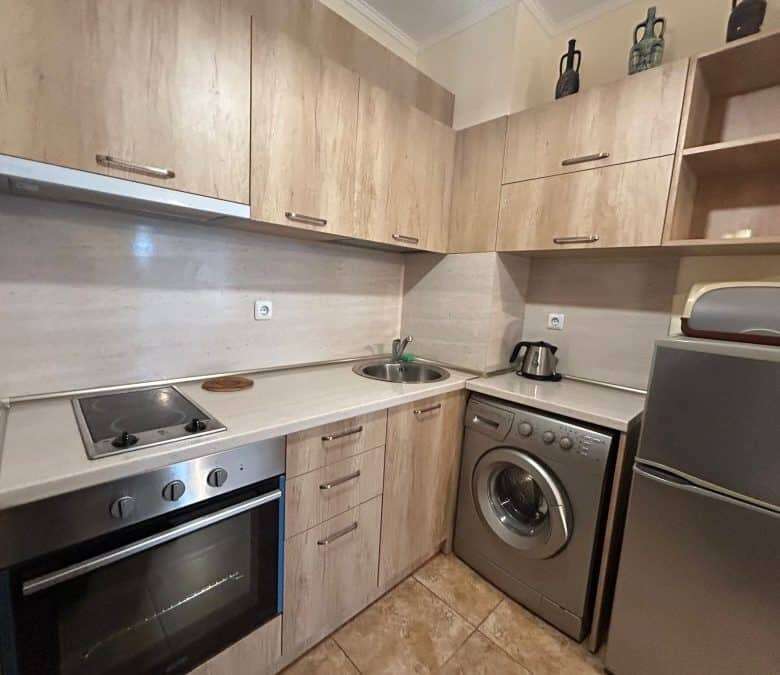 Modern fully furnished studio kitchen in Apollon apartments, Ravda with essential appliances and woo.