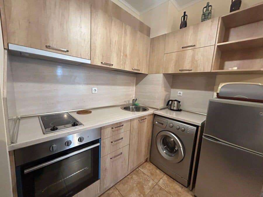Modern fully furnished studio kitchen in Apollon apartments, Ravda with essential appliances and woo.