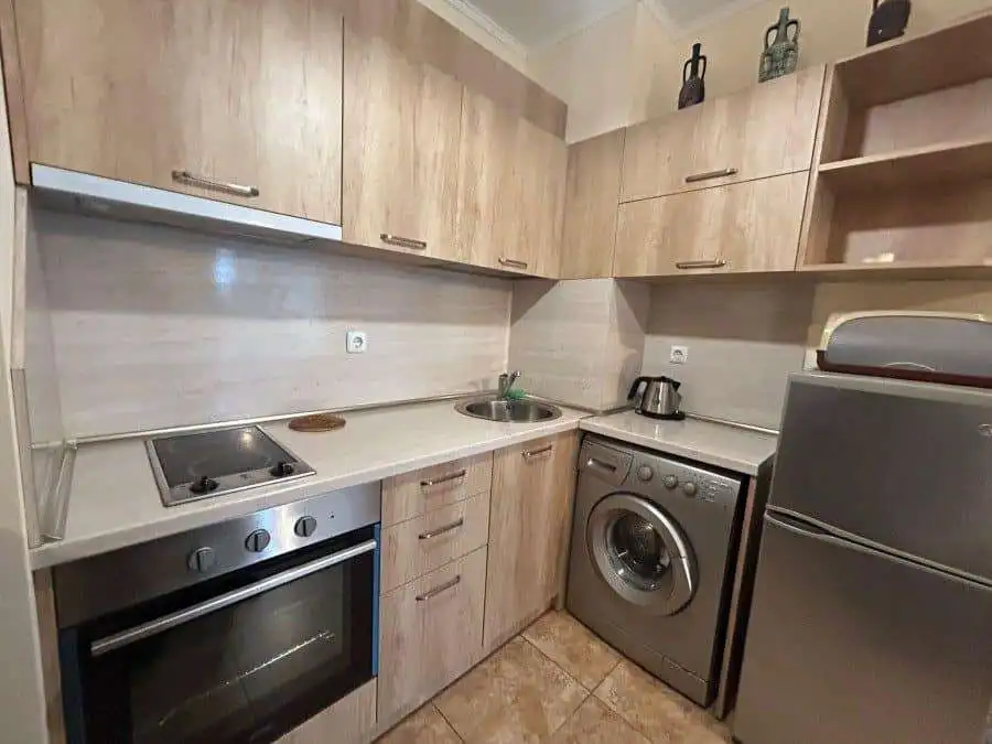 Modern fully furnished studio kitchen in Apollon apartments, Ravda with essential appliances and woo.