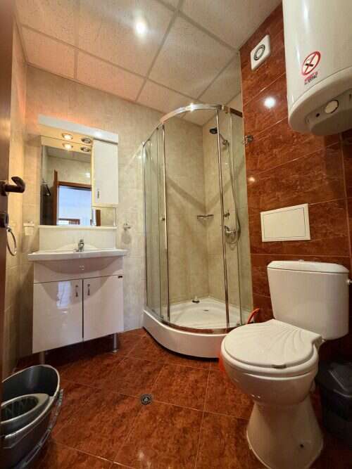Bright bathroom with shower cabin, toilet, and sink in a holiday apartment at Sunny Beach.