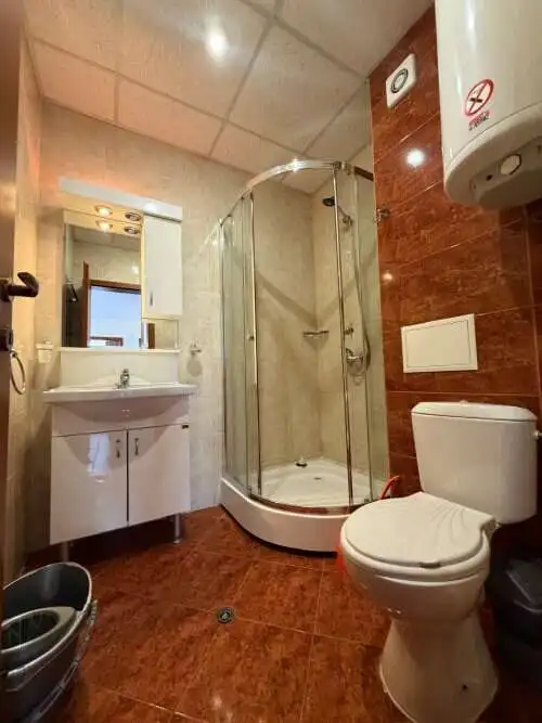 Bright bathroom with shower cabin, toilet, and sink in a holiday apartment at Sunny Beach.