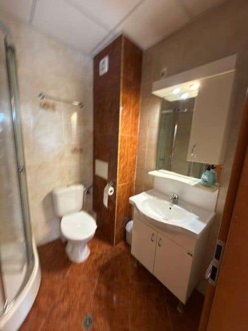 Bright bathroom with modern fixtures in a top-floor apartment at Holiday Fort Club.