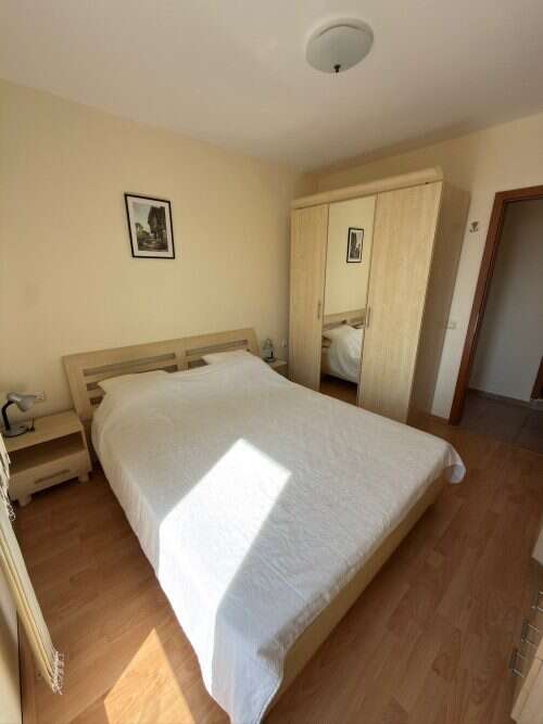 Bright bedroom with natural sunlight and modern furnishings.