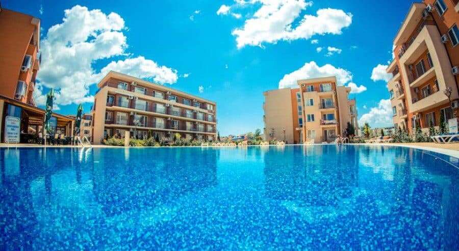 Bright outdoor pool area at Holiday Fort Club in Sunny Beach, close to the sea.