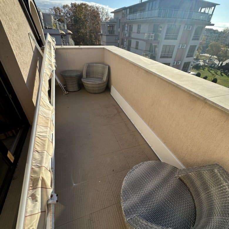Balcony of a furnished studio with seating area and panoramic views in Tarsis Club and SPA, Sunny Be.