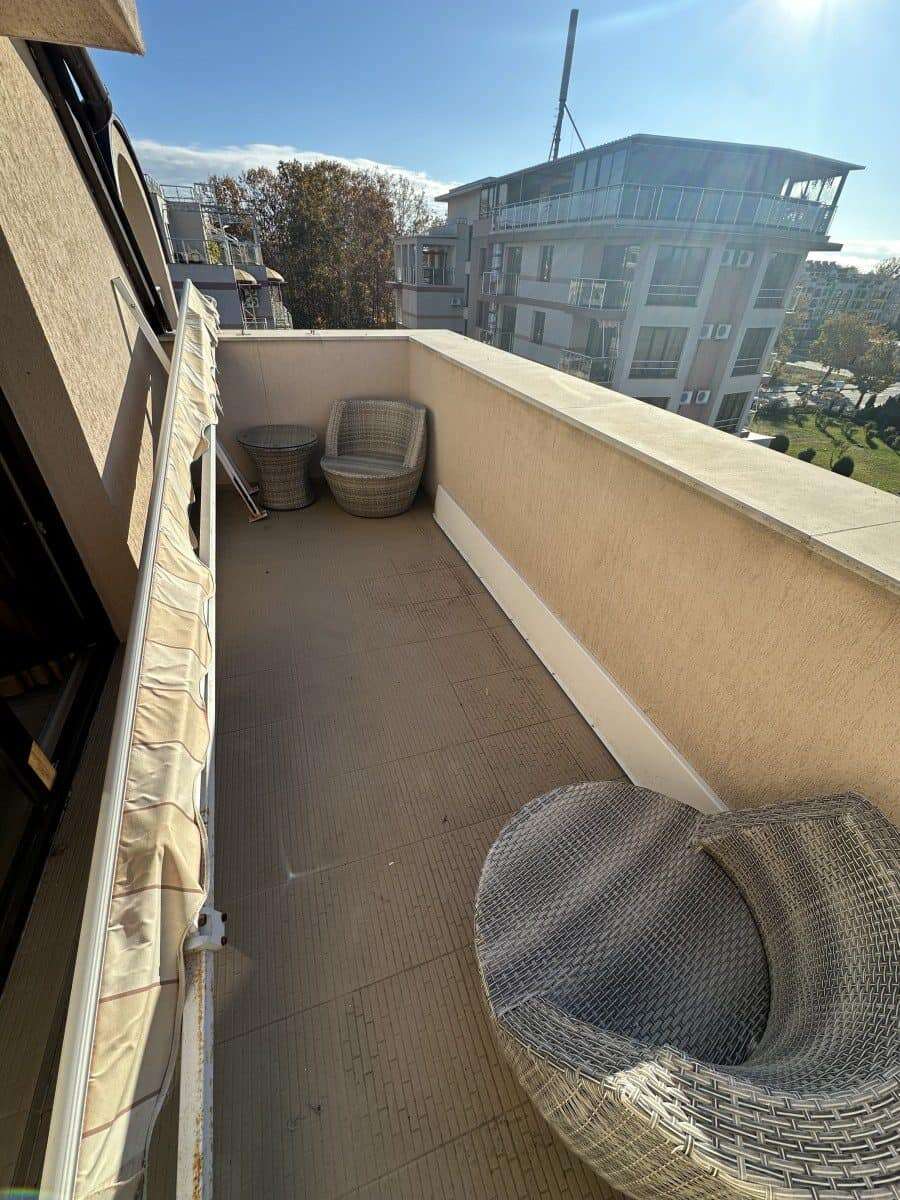 Balcony of a furnished studio with seating area and panoramic views in Tarsis Club and SPA, Sunny Be.