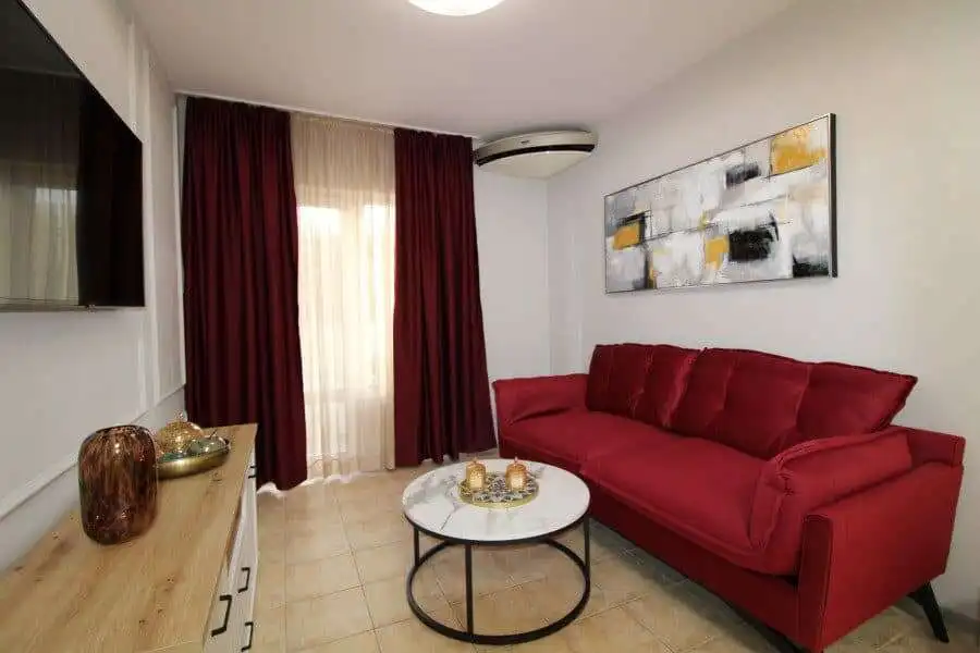 Bright living room with red sofa and modern decor in Sveti Vlas.