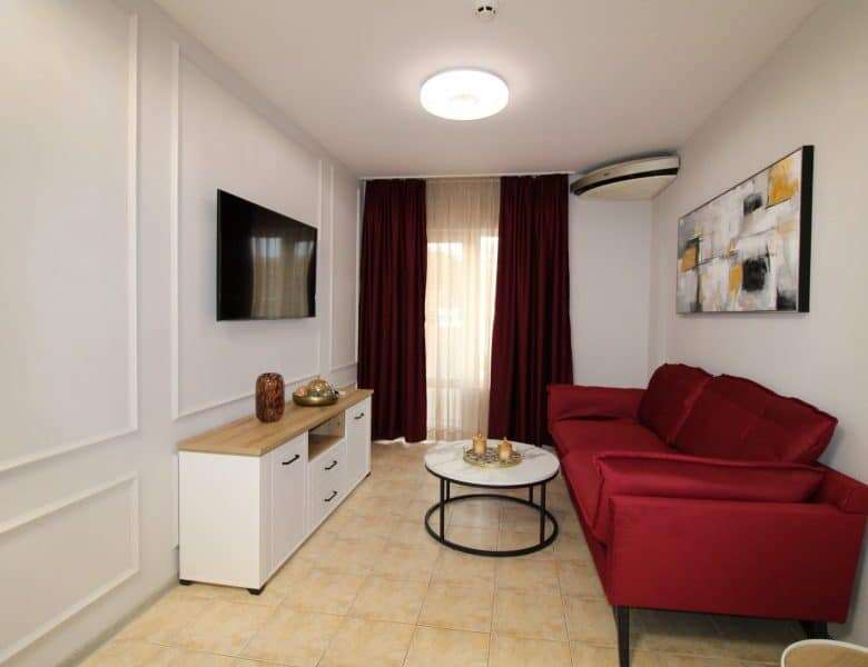 Bright living room with red sofa and modern decor in Belle Air, Sveti Vlas.