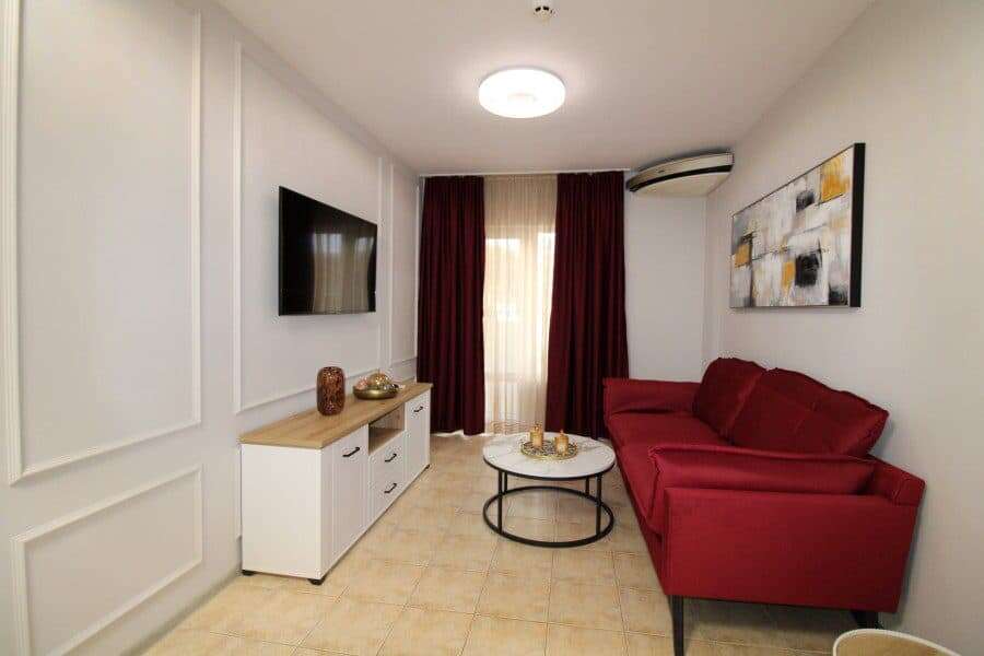 Bright living room with red sofa and modern decor in Belle Air, Sveti Vlas.