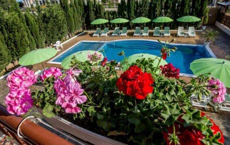Pool area with sun loungers and umbrellas in Sveti Vlas, near the sea.