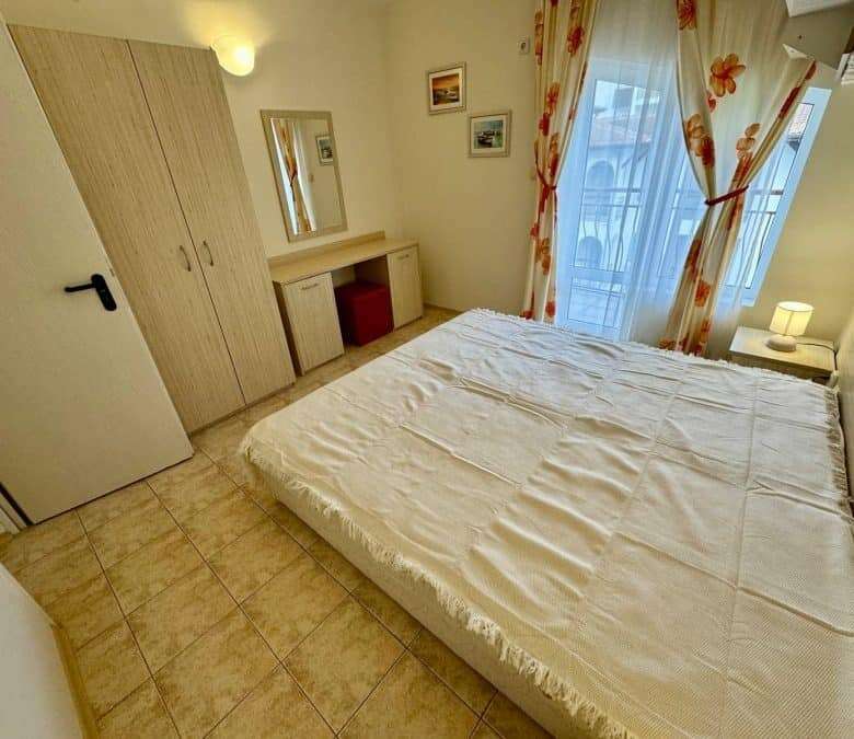 Bright bedroom with a large bed and balcony view in Sveti Vlas, close to the sea.