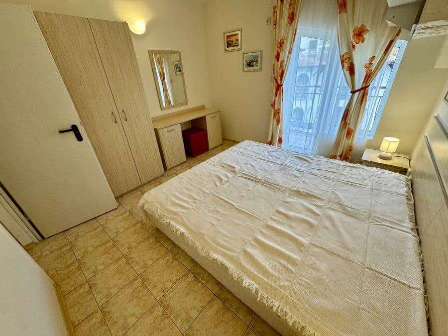 Bright bedroom with a large bed and balcony view in Sveti Vlas, close to the sea.