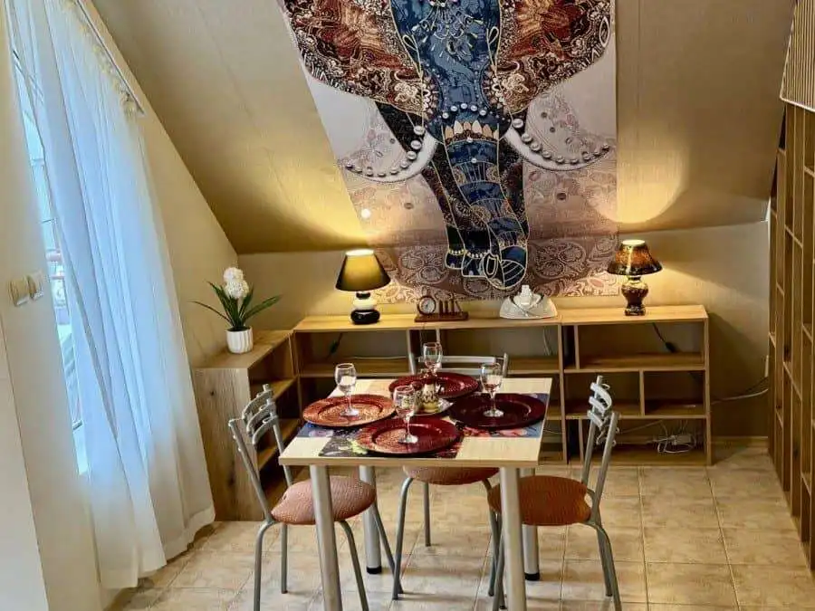 Modern dining space with a wooden table and four chairs, decorated with elegant tableware, featuring.