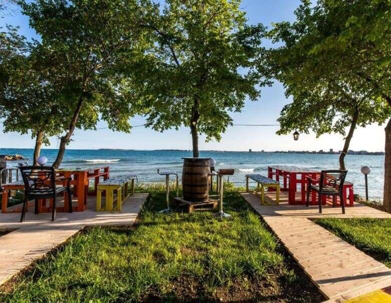 Beautiful outdoor dining space with tables and chairs near the sea in Sveti Vlas.