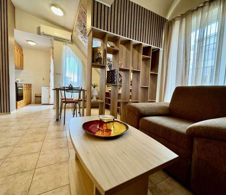 Bright living room with sofa and large windows.