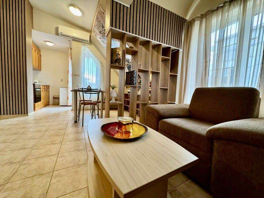 Bright living room with sofa and large windows.