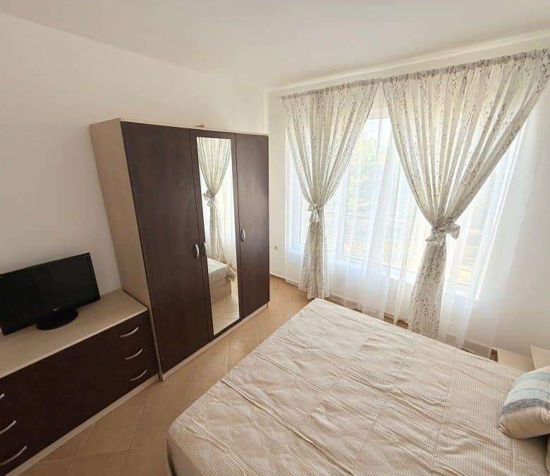 Sunny Beach 2-bedroom apartment with spacious living area and large windows.