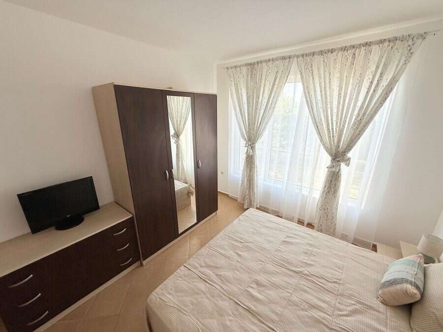 Sunny Beach 2-bedroom apartment with spacious living area and large windows.