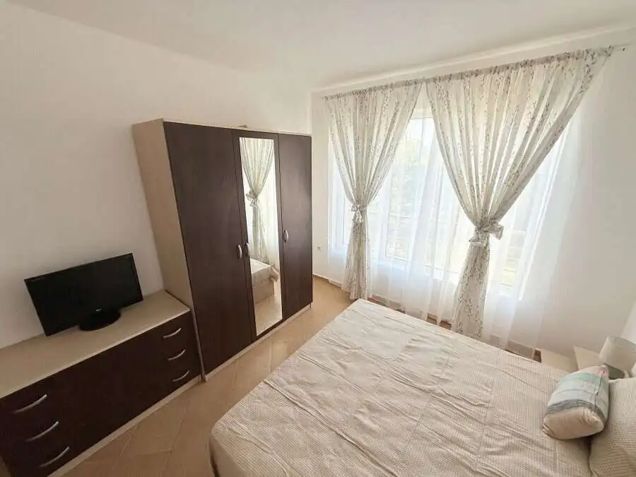 Sunny Beach 2-bedroom apartment with spacious living area and large windows.