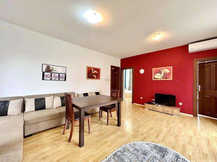Bright living room with stylish decor and wooden flooring near the sea.