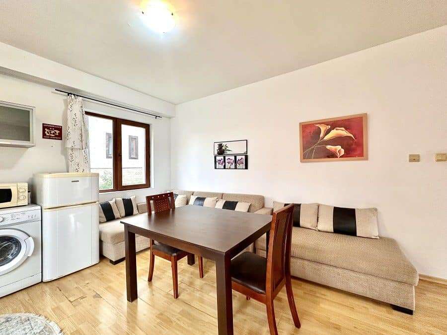 Bright living room with sofa and dining area, near the sea in Panorama Bay 1.