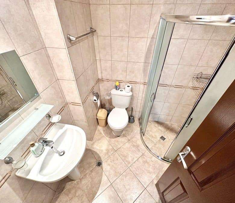 Bright bathroom with shower cabin and modern fixtures in Panorama Bay 1.