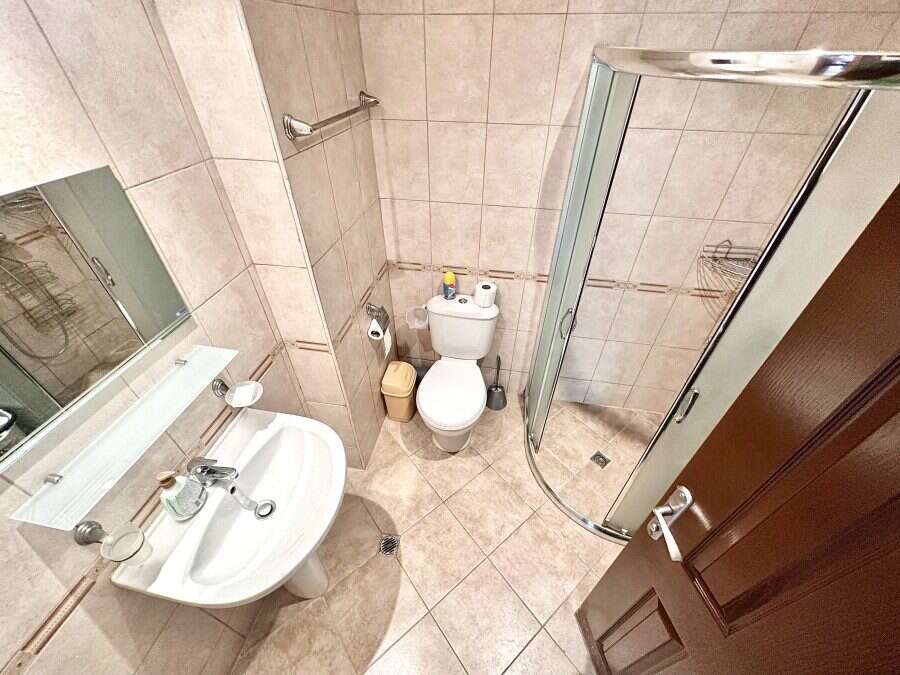 Bright bathroom with shower cabin and modern fixtures in Panorama Bay 1.