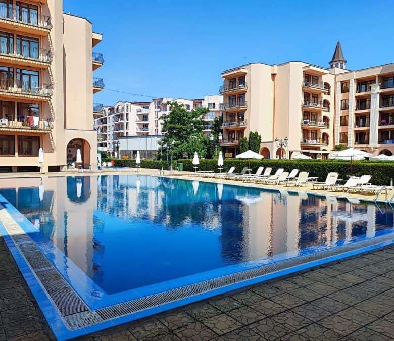 Pool view of a luxurious apartment complex in Sunny Beach with a large swimming pool and surrounding.