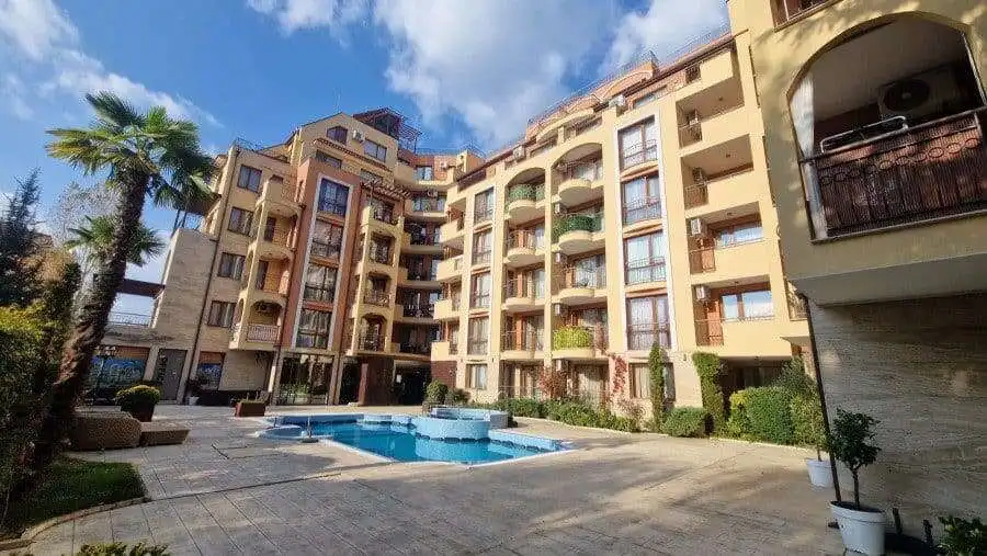 Pool view of a 1-bedroom apartment in Harmony Suites, surrounded by lush greenery and modern ameniti.