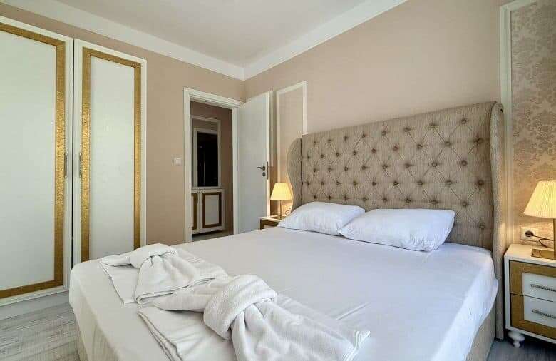Spacious bedroom with elegant decor in Harmony Suites, Monte Carlo.