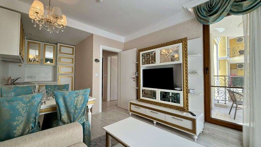 Luxury 1 Bed Apartment in Sunny Beach Bright living room with modern decor and balcony view.
