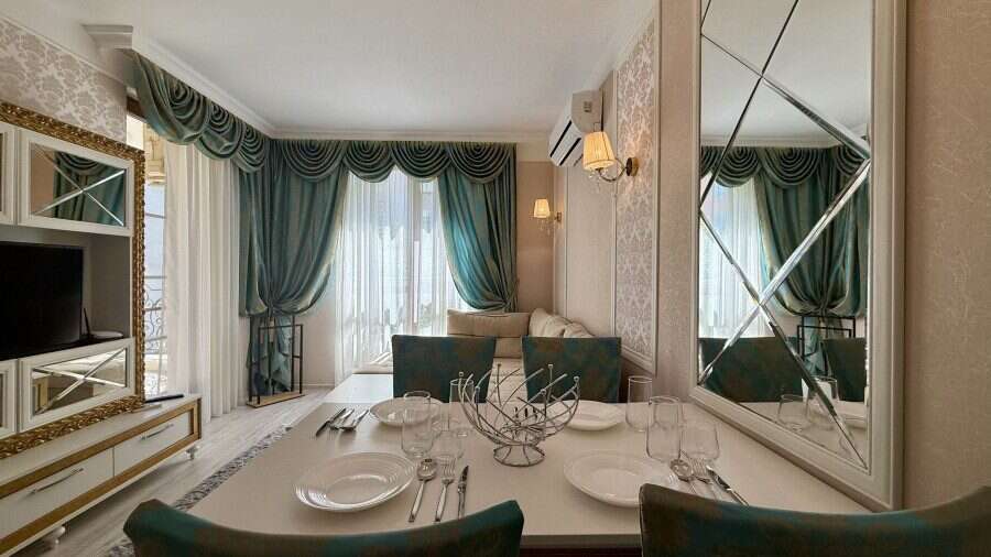 Luxury 1 Bed Apartment in Sunny Beach Bright living room with large windows and elegant curtains in Sunny Beach.