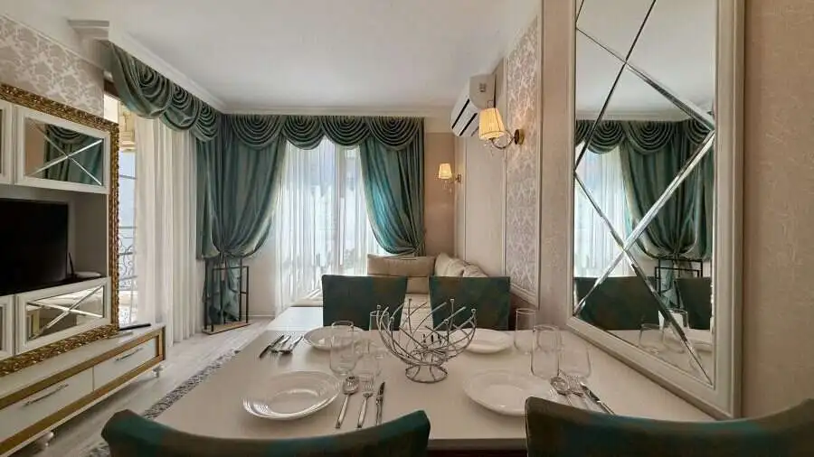 Bright living room with large windows and elegant curtains in Sunny Beach.