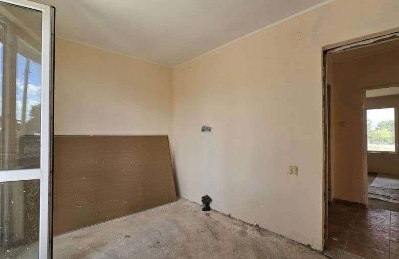 Interior view of a 2-bedroom bungalow in Dyulevo, Bulgaria, with a simple living space and natural l.