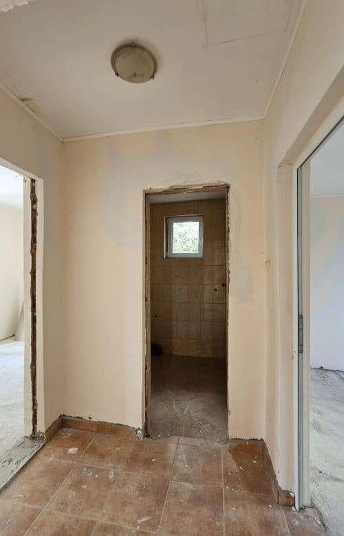 Interior view of a 2-bedroom bungalow in Dyulevo, Bulgaria, showing entryway and small window.