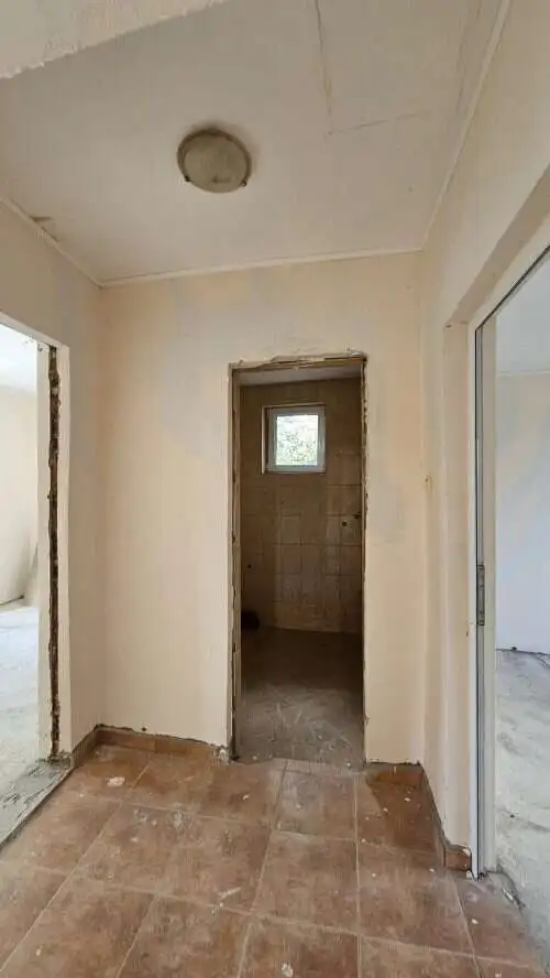 Interior view of a 2-bedroom bungalow in Dyulevo, Bulgaria, showing entryway and small window.