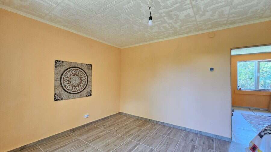 Renovated house interior with spacious living area and large window in Dyulevo, near Burgas, Bulgari.