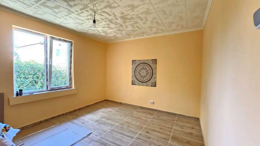 Renovated house interior with spacious room and large window in Dyulevo, near Burgas.