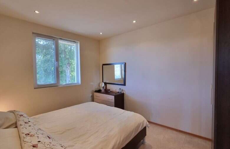 Cozy bedroom with large window and minimalist decor in Ropotamo Valley.