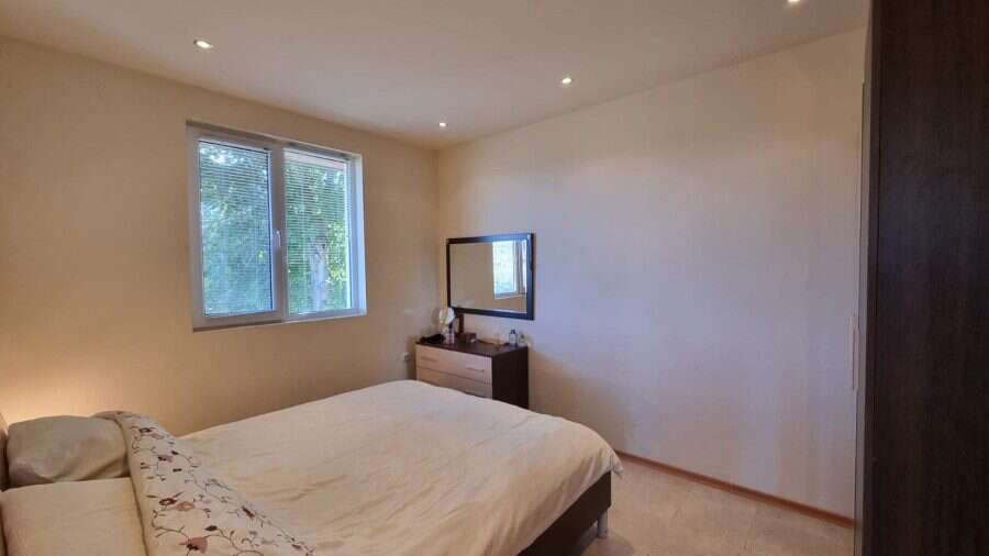 Cozy bedroom with large window and minimalist decor in Ropotamo Valley.