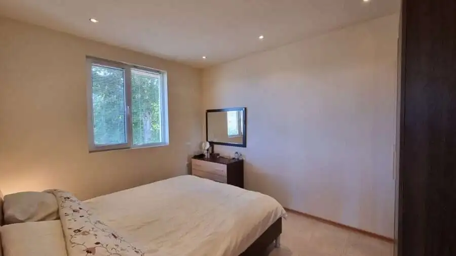 Cozy bedroom with large window and minimalist decor in Ropotamo Valley.